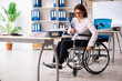 © Elnur - Female employee in wheel-chair at the office