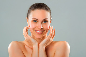 Wall Mural - beautiful young woman with a smile on a blue background