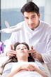 © Elnur - Young woman visiting male doctor cosmetologist