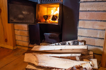 Sauna Stove, Firewood And Fire In The Stove. The Concept Of A Bath, Sauna, Health Care, Cleanliness, Body Treatments.