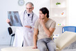 © Elnur - Young man visiting old male doctor radiologist