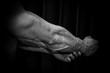 © Yuliia - athlete shows pumped hand close-up on a black background. bodybuilding mr. olympia