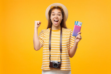 Wall Mural - Good-looking European girl with retro camera on neck isolated on background holding airticket and shouting with joy