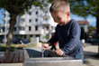 © Miljan Živković - Little boy at the public fountain playing with water drinking in summer sunny day thirsty refreshment