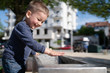 © Miljan Živković - Little boy at the public fountain playing with water drinking in summer sunny day