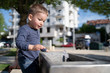 © Miljan Živković - Little boy at the public fountain playing with water drinking in summer sunny day thirsty refreshment