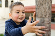 © Miljan Živković - Small boy holding a tree at the city square