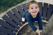 © Miljan Živković - High angle view on small boy holding a tree by the bench at city square want to climb