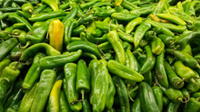 Detail Of Fresh Green California Or Anaheim Chili Peppers. Also Called Green Chiles From The North In Mexico. Grouped On The Shelf Of A Supermarket.