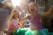 © Adam Hester - Two toddler aged girls playing together outside on a sunny day.