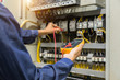 © A Stockphoto - Electrician engineer work  tester measuring  voltage and current of power electric line in electical cabinet control.
