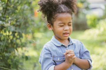 little girl praying. kid prays. Gesture of faith.Hands folded in prayer concept for faith,spirituality and religion