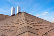 © brizmaker - Asphalt tile roof with chimney on new home under construction