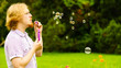 © Voyagerix - Man blowing soap bubbles outdoor