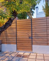 Poster - contemporary house entrance fence and door late in the  evening