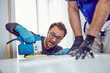 © astrosystem - Two handymen working together on a house renovation.