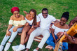 © yurakrasil - Group of smiling happy afro-american friends friends playing guitar outdoors picnic in the campaign
