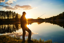 Sunset Fishing. Fisher With Spinning Rod