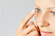 © Olesia - Young woman puts contact lens in her eye. Eyewear, eyesight and vision, eye care and health, ophthalmology and optometry concept, selective focus