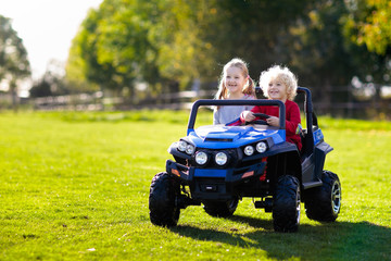 Kids driving electric toy car. Outdoor toys.