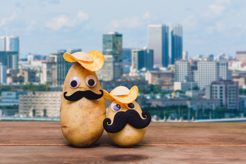 funny potato on city background