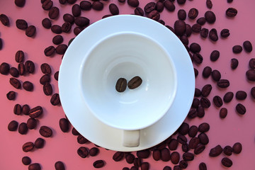 Still life with a clean coffee Cup and saucer and coffee beans scattered on the table