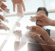 © yurolaitsalbert - bottom view. business team folding puzzle pieces.