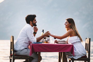 Wall Mural - Happy couple on summer evening having romantic dinner outdoor