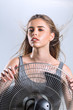 © Svetlana Radayeva - Young woman enjoying cool wind from electric fan