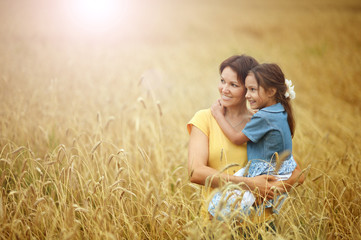 Canvas Print - Portrait of mother and daughter at field