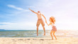 © tonefotografia - Couple is Jumping  in beach
