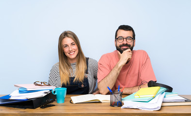 Students with many books laughing