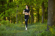 © Bogdan - Sexy, sporty girl with a beautiful figure wearing a sports brassiere and leggings, doing sport exercises, outdoor running