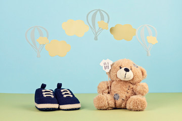 Small cute baby boy shoes over the blue background