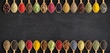 Spices and herbs in wooden spoons for website headers. Collection of spices with an empty space for an inscription or label.
