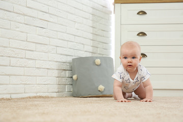 Canvas Print - Cute little baby crawling on carpet indoors