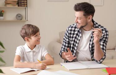 Sticker - Dad helping his son with school assignment at home