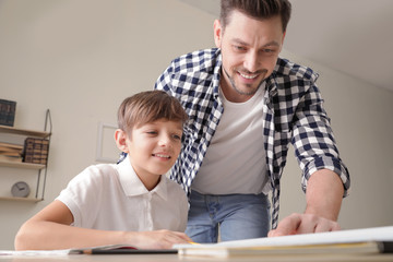 Sticker - Dad helping his son with school assignment at home