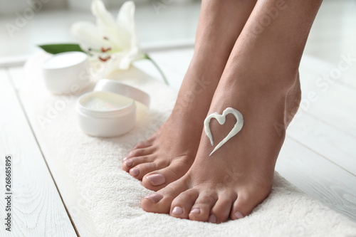 Woman with beautiful feet and cream on white towel, closeup Wallpaper Mural
