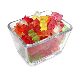 Glass bowl with delicious jelly bears on white background