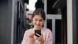 © tirachard - Cheerful Asian backpacker blogger woman using smartphone for direction and looking on location map while traveling at Chinatown in Beijing, China. Lifestyle backpack tourist travel holiday concept.
