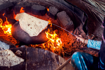 Arab woman makes bread in the beduin village in Egypt