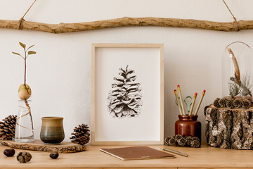 Wall Mural - Stylish and scandinavian interior of living room with mock up poster frame, wooden accessories, avocado plant, forest cones, plants, notes and personal stuff. Minimalistic and botanical home decor. 