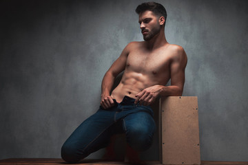 Canvas Print - Charming topless man posing and pulling his jeans