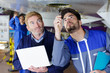 © auremar - mechanics inspecting underneath an aircrafts fuselage