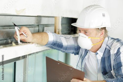 male tradesman wearing a mask inspecting property