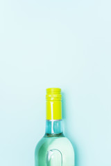 Wall Mural - Screw bottle foil caps in different bright colors of white and rose wine bottles on blue background with copy space. Minimal abstract colorful mockup concept of alcohol beverage. Flat lay.
