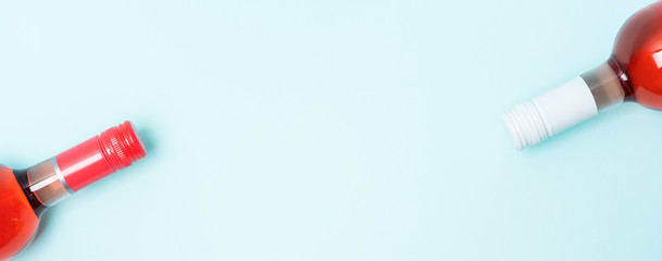Wall Mural - Colorful bottle caps of white and rose wine bottles on turquoise background. Minimal abstract colorful layout concept of summer time alcohol beverage. Long wide banner.
