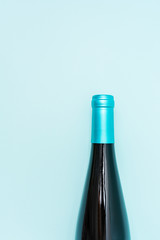 Wall Mural - Screw bottle foil caps in different bright colors of white and rose wine bottles on blue background with copy space. Minimal abstract colorful mockup concept of alcohol beverage. Flat lay.