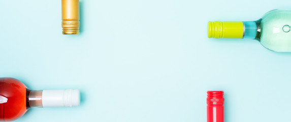 Wall Mural - Colorful bottle caps of white and rose wine bottles on turquoise background. Minimal abstract colorful layout concept of summer time alcohol beverage. Long wide banner.